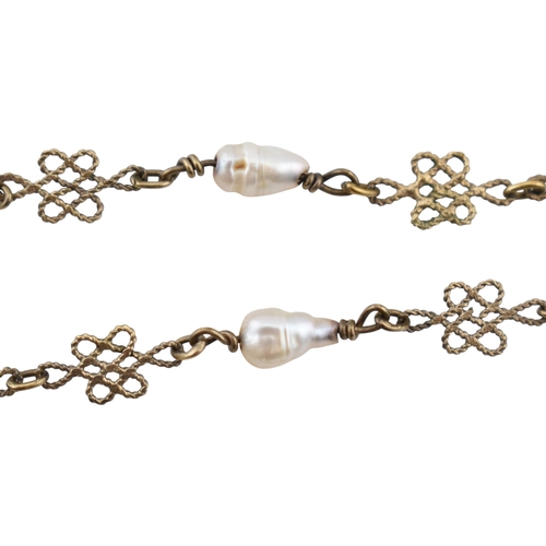 350 - A yellow metal and pearl pendant fancy knot link necklace. AF. Weight 4.8g. Measures 45cm