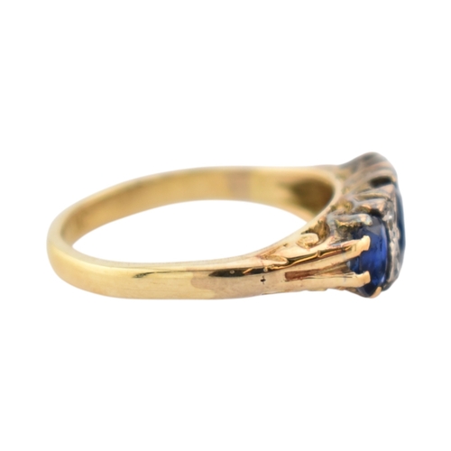 354 - An 18ct gold sapphire and diamond three stone ring. Stamped 18ct. Weight 2.8g. Size J