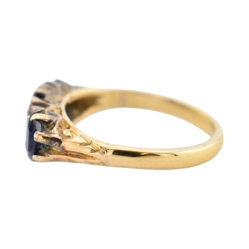 354 - An 18ct gold sapphire and diamond three stone ring. Stamped 18ct. Weight 2.8g. Size J