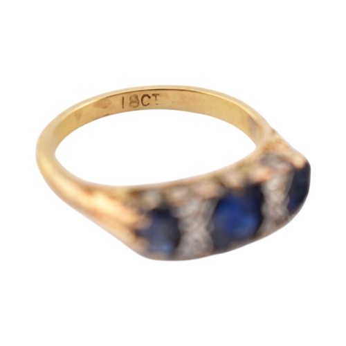 354 - An 18ct gold sapphire and diamond three stone ring. Stamped 18ct. Weight 2.8g. Size J