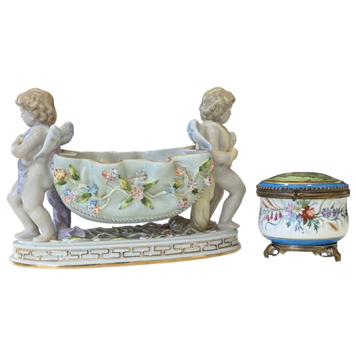 100 - A 20th century German Dresden style porcelain centre piece having figural putti to each side with fl... 