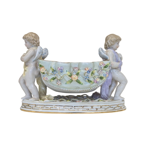 100 - A 20th century German Dresden style porcelain centre piece having figural putti to each side with fl... 