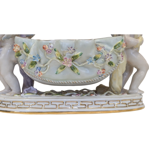 100 - A 20th century German Dresden style porcelain centre piece having figural putti to each side with fl... 