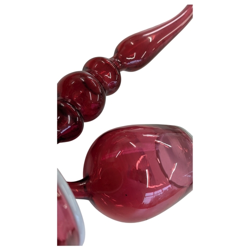 114 - A collection of four 19th century Victorian glass Nailsea pipes. Cranberry glass with white rims on ... 