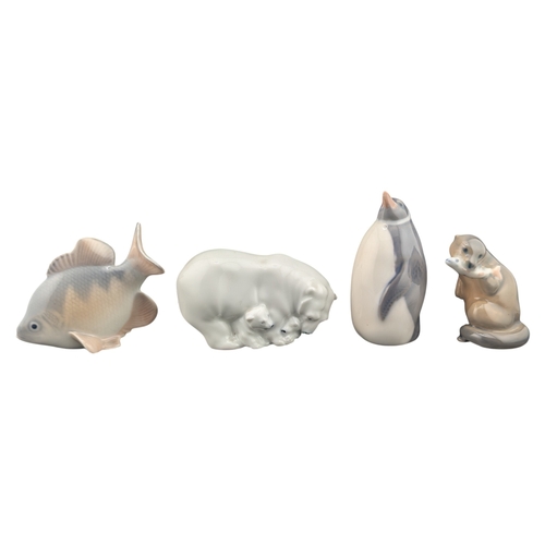 77 - Royal Copenhagen - Four 20th century vintage porcelain animal figures. Comprising of 3003 Penguin, 2... 