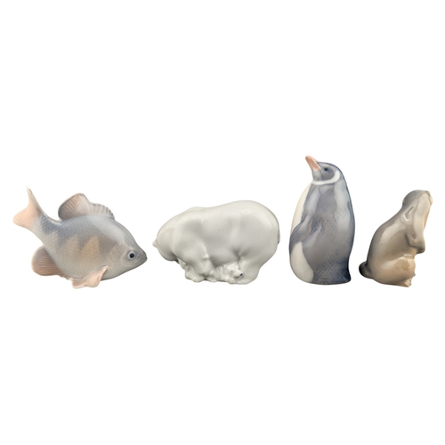 77 - Royal Copenhagen - Four 20th century vintage porcelain animal figures. Comprising of 3003 Penguin, 2... 