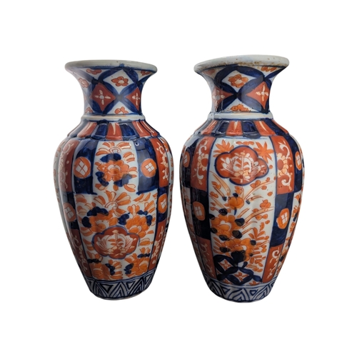 94 - Pair of late 19th century Japanese imari vases. Of scalloped baluster form and decorated with a red ... 