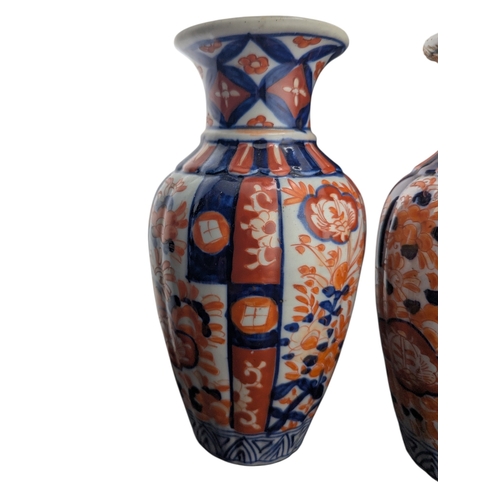 94 - Pair of late 19th century Japanese imari vases. Of scalloped baluster form and decorated with a red ... 