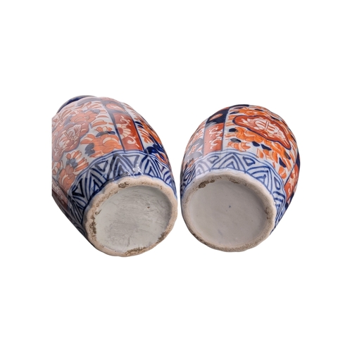 94 - Pair of late 19th century Japanese imari vases. Of scalloped baluster form and decorated with a red ... 