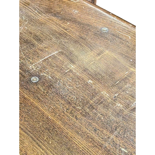 618 - Ercol Furniture, High Wycombe - A vintage 20th century golden dawn elm dining table. Large plank rec... 