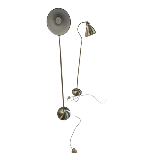 622 - Two contemporary floor standing metal lamps. In a gilt colourway with curved arm terminating in coni... 