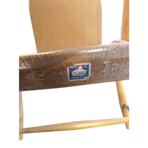 626 - Ercol Furniture - A 20th century Ercol comb-back double bow ' Chairmakers ' Windsor armchair. Of bee... 