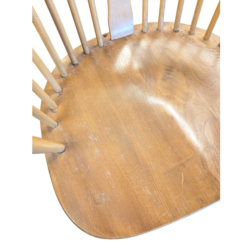 626 - Ercol Furniture - A 20th century Ercol comb-back double bow ' Chairmakers ' Windsor armchair. Of bee... 