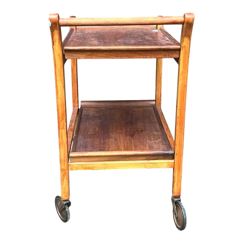 627 - British Modern Design - A mid century teak wood butlers trolley. Raised on squared legs with twin ti... 
