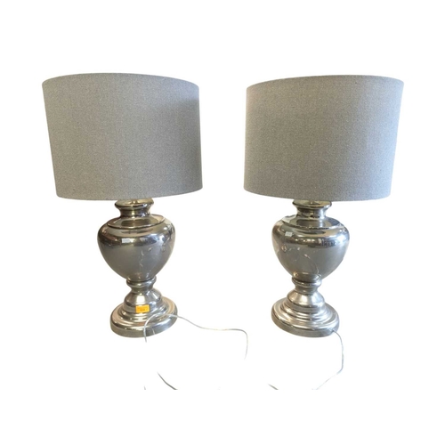 634 - Pair of contemporary polished silver metal table lamps. Having grey conical shades on silver bulbous... 