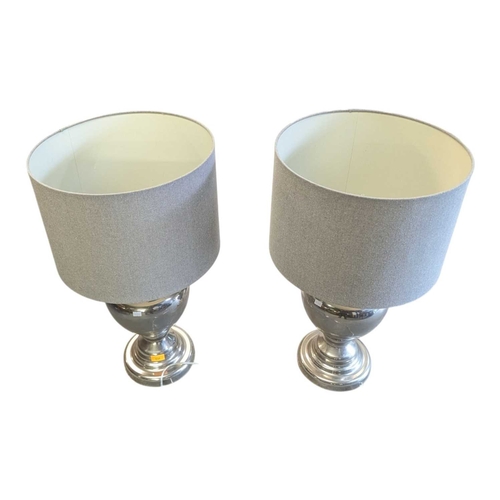 634 - Pair of contemporary polished silver metal table lamps. Having grey conical shades on silver bulbous... 