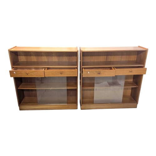 644 - Two Nathan (now Parker Knoll) teak bookcases, each having two central drawers adding to the appeal o... 