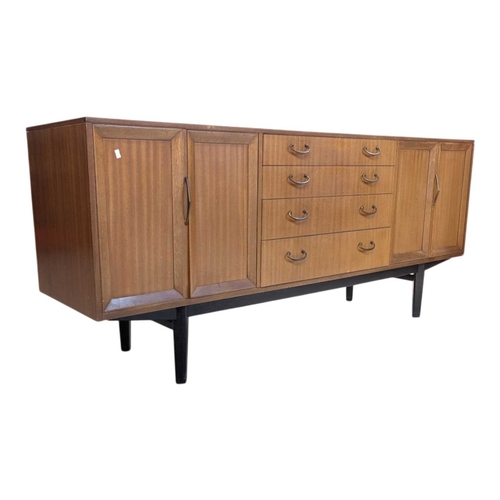 646 - A mid-century British design teak sideboard, consisting of a central bank of 4 drawers with double p... 