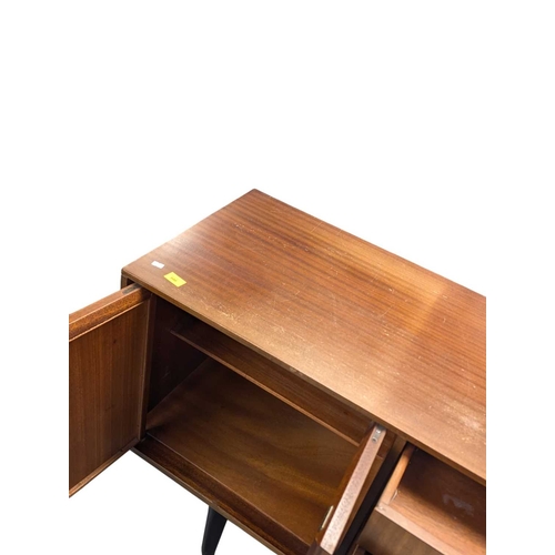 646 - A mid-century British design teak sideboard, consisting of a central bank of 4 drawers with double p... 