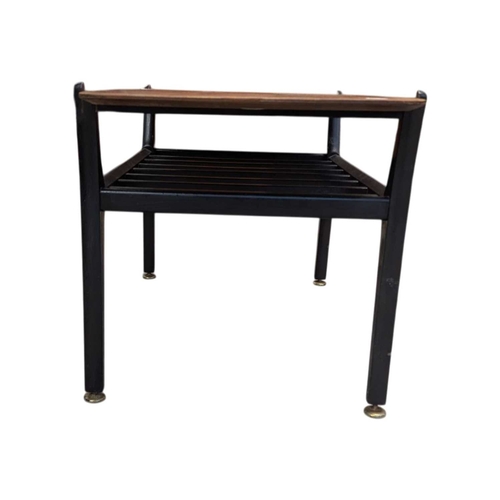 648 - A mid-century British design tola wood coffee table with ebonised legs and slatted magazine rack bel... 