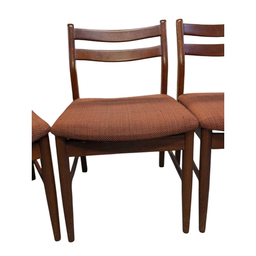 649 - British Modern Design - Set of four mid century teak dining chairs. Angled back splats with padded s... 
