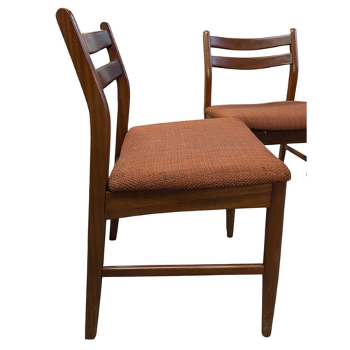 649 - British Modern Design - Set of four mid century teak dining chairs. Angled back splats with padded s... 