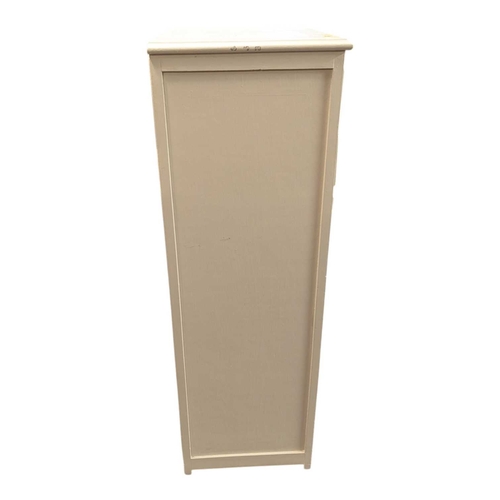 650 - A 20th century white painted semainier pedestal chest of drawers. The chest having a bank of eight d... 