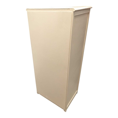 650 - A 20th century white painted semainier pedestal chest of drawers. The chest having a bank of eight d... 