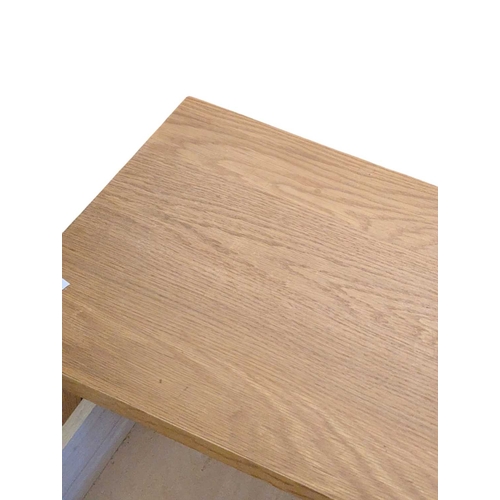 652 - A pair of contemporary oak bedside tables / side tables. Each having overhanging top with drawer ben... 