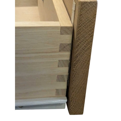 652 - A pair of contemporary oak bedside tables / side tables. Each having overhanging top with drawer ben... 