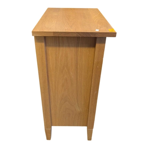 652 - A pair of contemporary oak bedside tables / side tables. Each having overhanging top with drawer ben... 