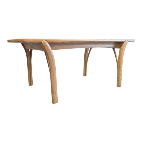 659 - Oak contemporary coffee table. Rectangular plank form with tapeing curved legs and supports with sma... 
