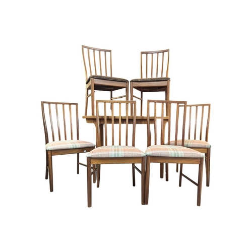 664 - Mid century teak extending dining table along with a set of 4 curved spindle back chairs having tart... 