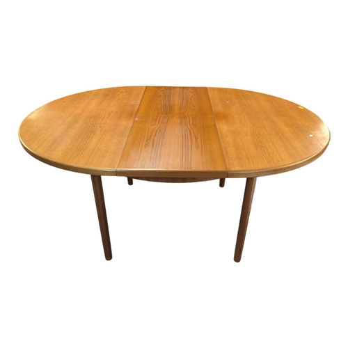664 - Mid century teak extending dining table along with a set of 4 curved spindle back chairs having tart... 