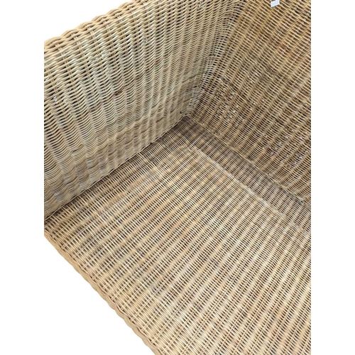 666 - A large contemporary rattan whicker weave conservatory sofa with large squab white cushions. Measure... 