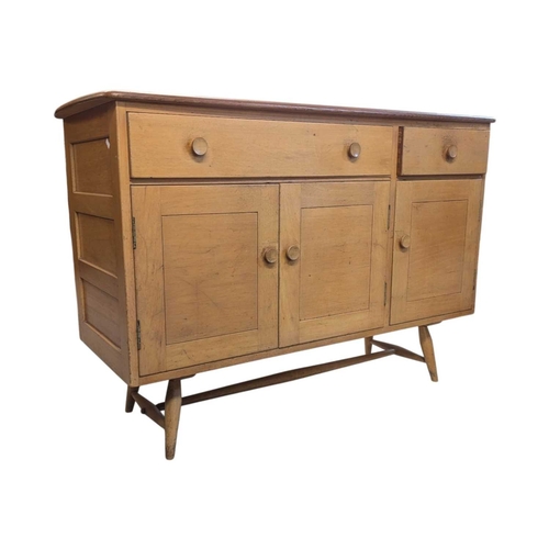668 - Ercol Furniture - A retro mid century beech & elm sideboard credenza. Rectangular plank form wit... 