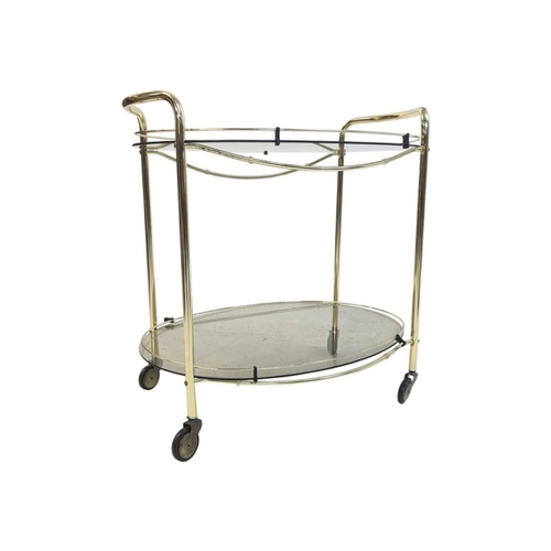 674 - A contemporary brass and smoked glass drinks / hostess trolley in the Art Deco style. Having gilt tu... 