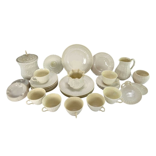 135 - A 20th century Irish Belleek lustre porcelain part tea service in the twisted shell shape. The servi... 
