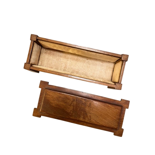 139 - An Arts & Crafts early 20th century walnut jewellery casket box in the form of a coffer chest. A... 