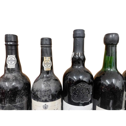 207 - An assortment of seven vintage Port bottles. The lot to include a Sandeman vintage 1970 port bottle,... 