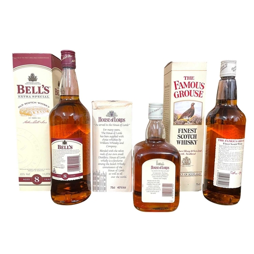 219 - Three assorted old Scotch whisky bottles. To include a House of Lords Deluxe blended Scotch whisky b... 