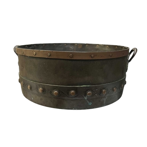 540 - A 19th century copper & studded bucket/cauldron. The large bucket of circular tapering form with... 