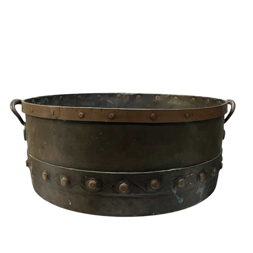540 - A 19th century copper & studded bucket/cauldron. The large bucket of circular tapering form with... 