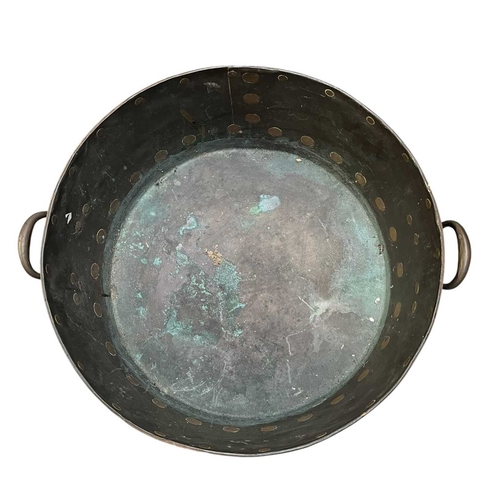 540 - A 19th century copper & studded bucket/cauldron. The large bucket of circular tapering form with... 