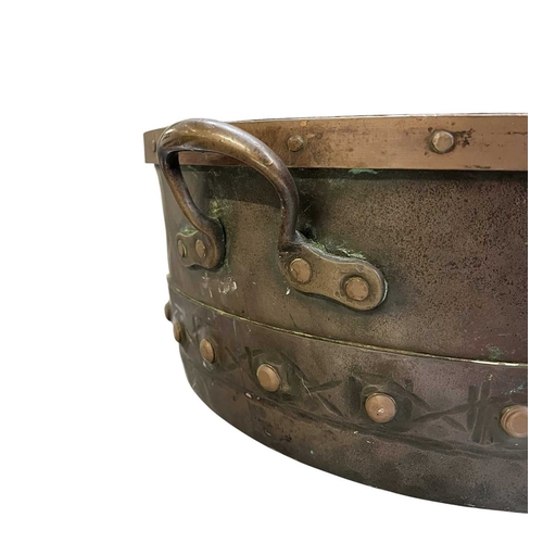 540 - A 19th century copper & studded bucket/cauldron. The large bucket of circular tapering form with... 