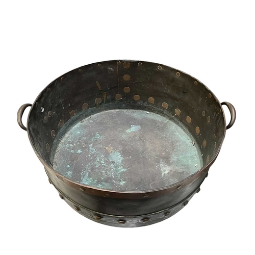 540 - A 19th century copper & studded bucket/cauldron. The large bucket of circular tapering form with... 