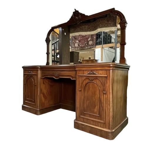543 - A large 19th century mahogany twin pedestal mirror back sideboard. The sideboard raised on twin pede... 