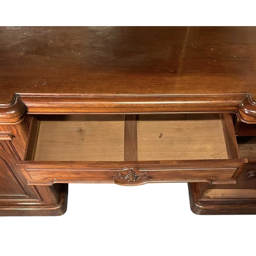543 - A large 19th century mahogany twin pedestal mirror back sideboard. The sideboard raised on twin pede... 