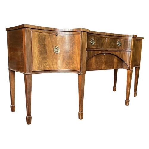 616 - A George III late 18th century mahogany sideboard credenza. The sideboard having serpentine curved f... 