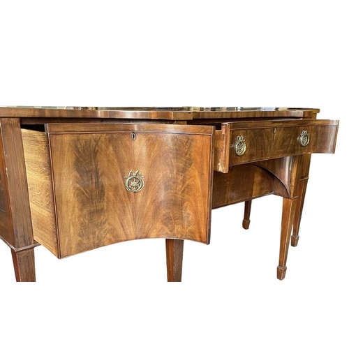 616 - A George III late 18th century mahogany sideboard credenza. The sideboard having serpentine curved f... 